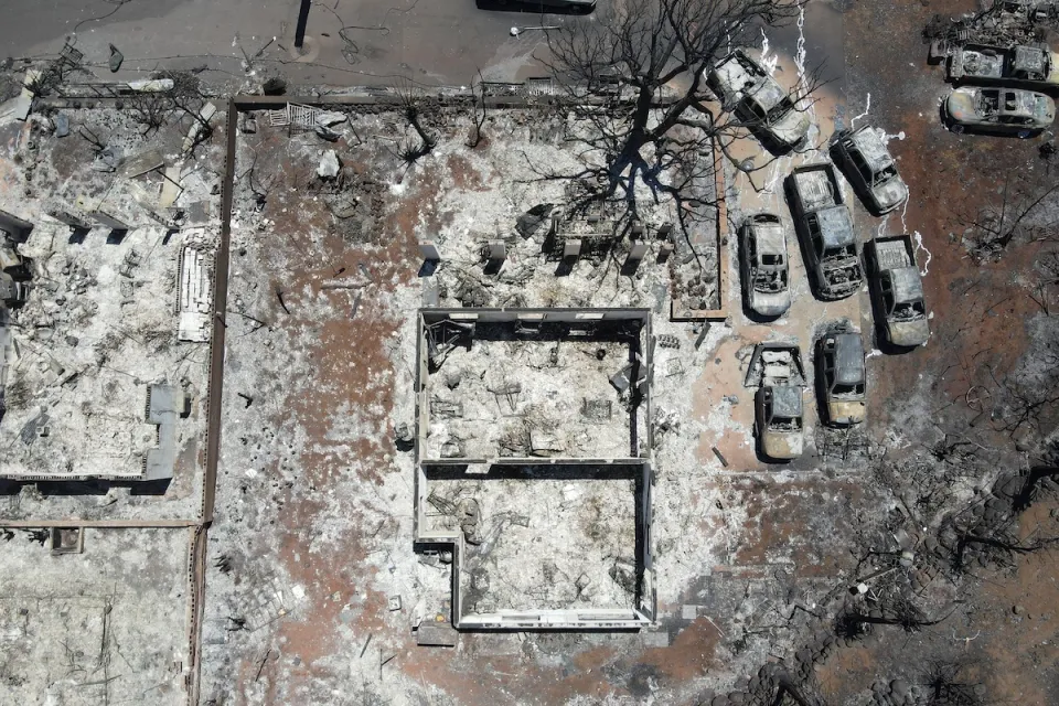 Aerial view of destroyed home and cars after Lahaina, Hawaii wildfires.